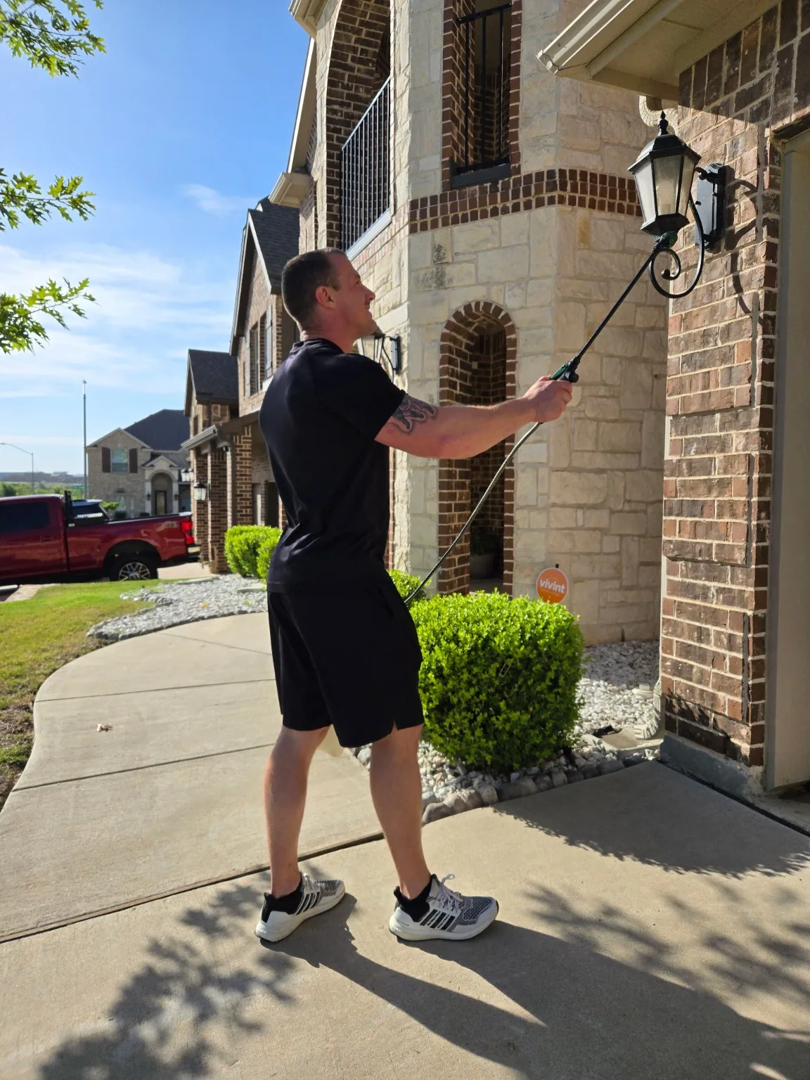 Bug Lock treating eaves on a North Texas home